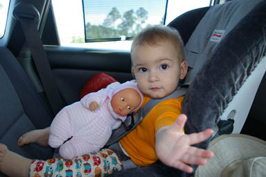 Sungiva reaches out from her car seat.