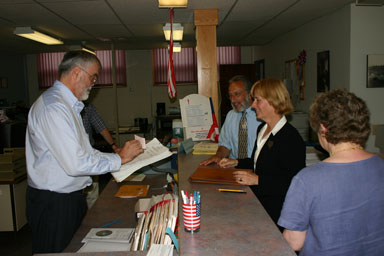 Election Commissioner Steve DeWitt examines District Attorney candidate Gwen Wilkinson's petitions