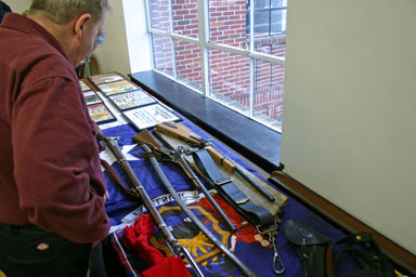 A visitor examines guns from Canfield's collection