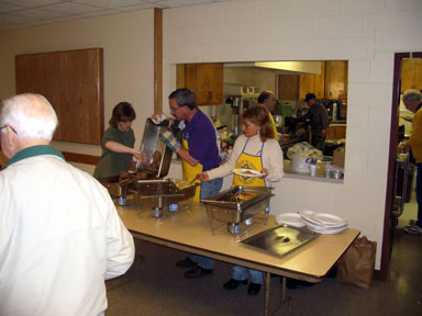 Volunteers serve pancakes at the Sertoma breakfast