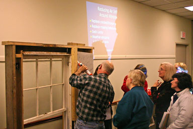 Mark Pierce showing how to to caulk leaks around window casings.