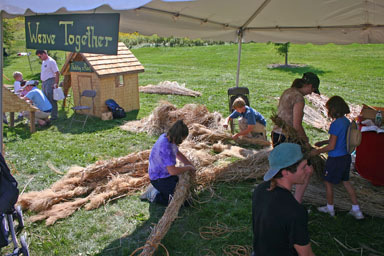 Weaving grass to thatch a roof