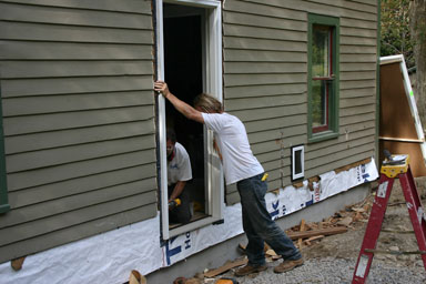 Installing the new steel door.