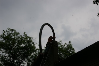 Putting the liner in the chimney.