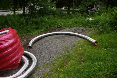 Piece of stainless steel chimney liner.