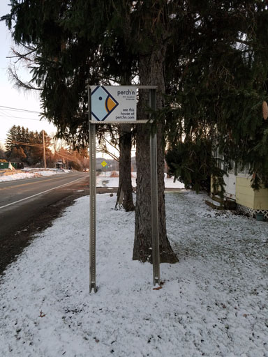 Frame for Town of Dryden sign with student rentals sign in its place.