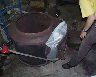 taking away the cast iron top of the furnace