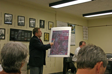 Dean of College Services Bob Ross points out the dormitory location on a satellite photo