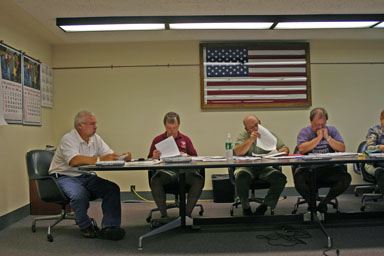 Town Board members review a proposal